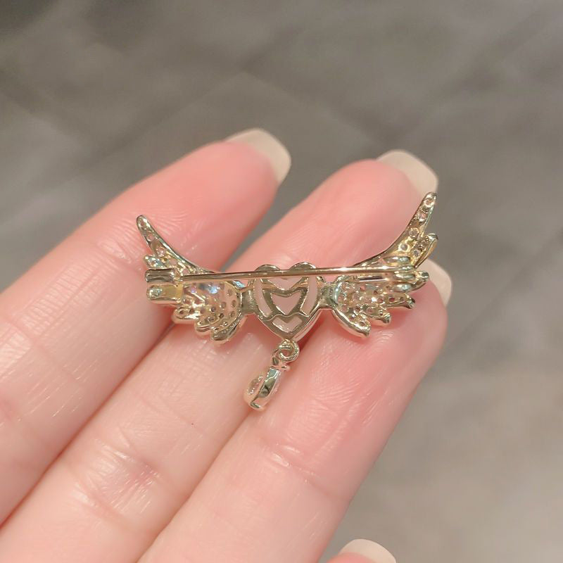 Celestial Wings: Heart & Angel Wing Brooch with Pearl Accents