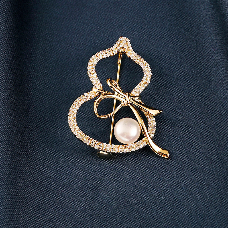 Modern Gourd: Lustrous Pearl Brooch & Gilded Statement Pin