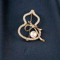 Modern Gourd: Lustrous Pearl Brooch & Gilded Statement Pin